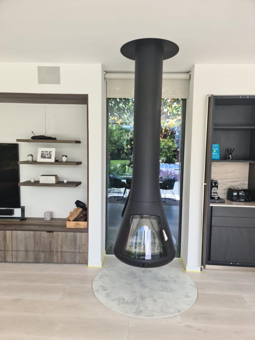 Open-plan room with suspended fireplace