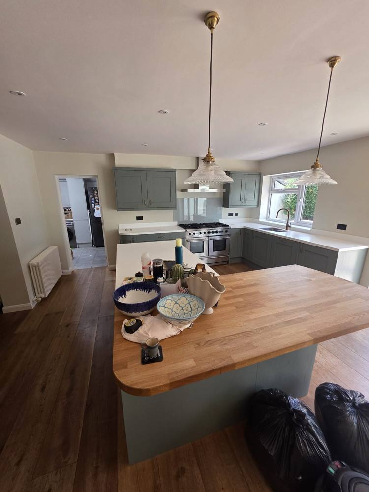 Painted sage kitchen with oak-topped island