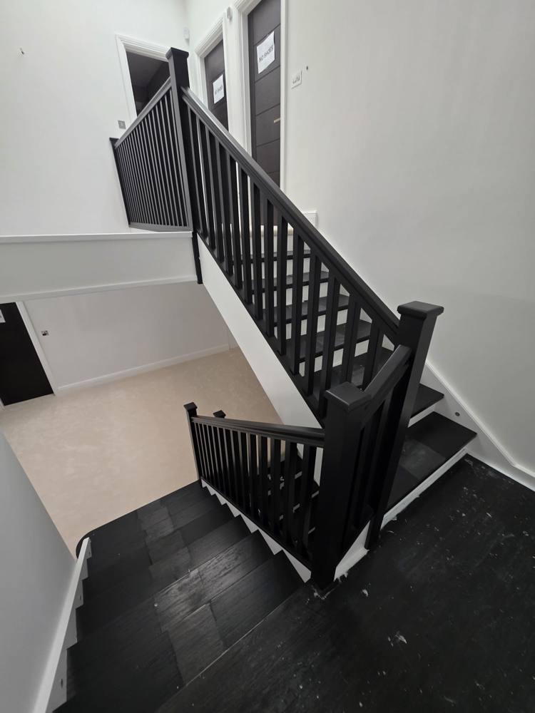 Staircase with black painted balustrade