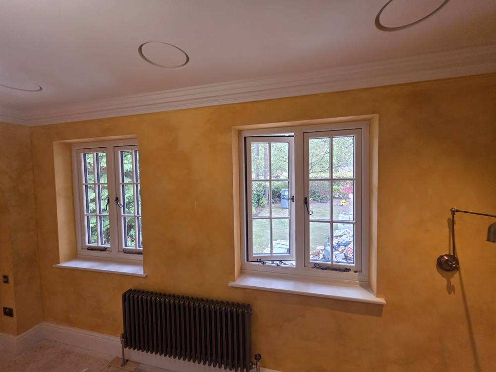 Golden limewash walls between two windows